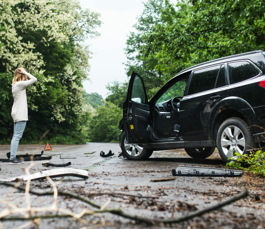 Young Woman Standing By The Damaged Car After A Ca       Utc Scaled E x