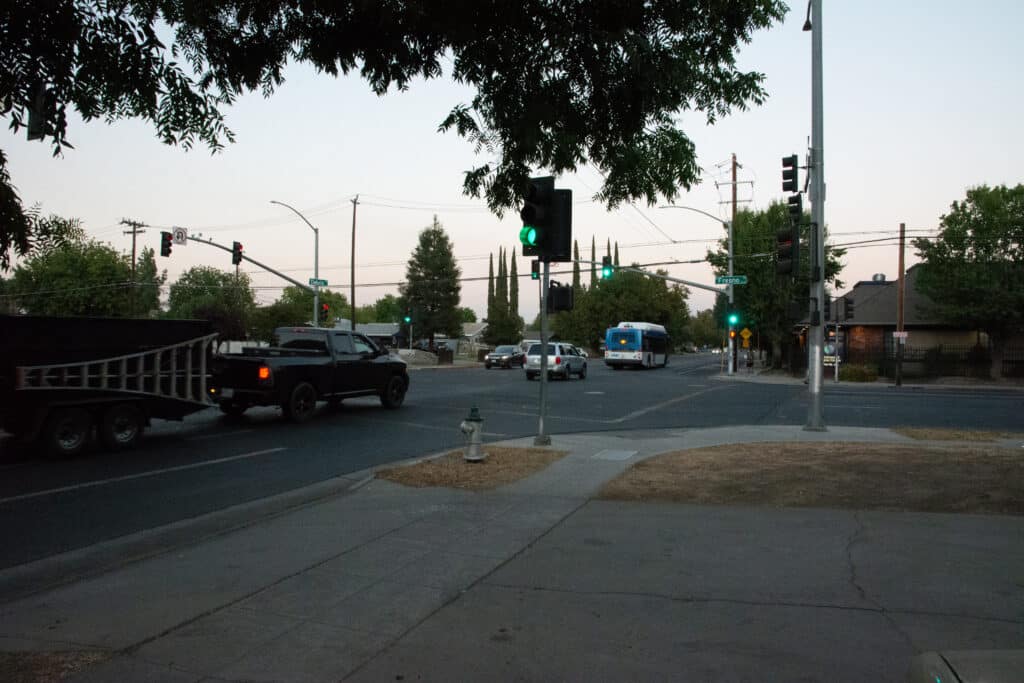 Traffic at intersection of Dakota Avenue and Fresno Street. Green light.