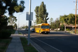 Fresno School Bus leading line of traffic along Barstow Avenue.