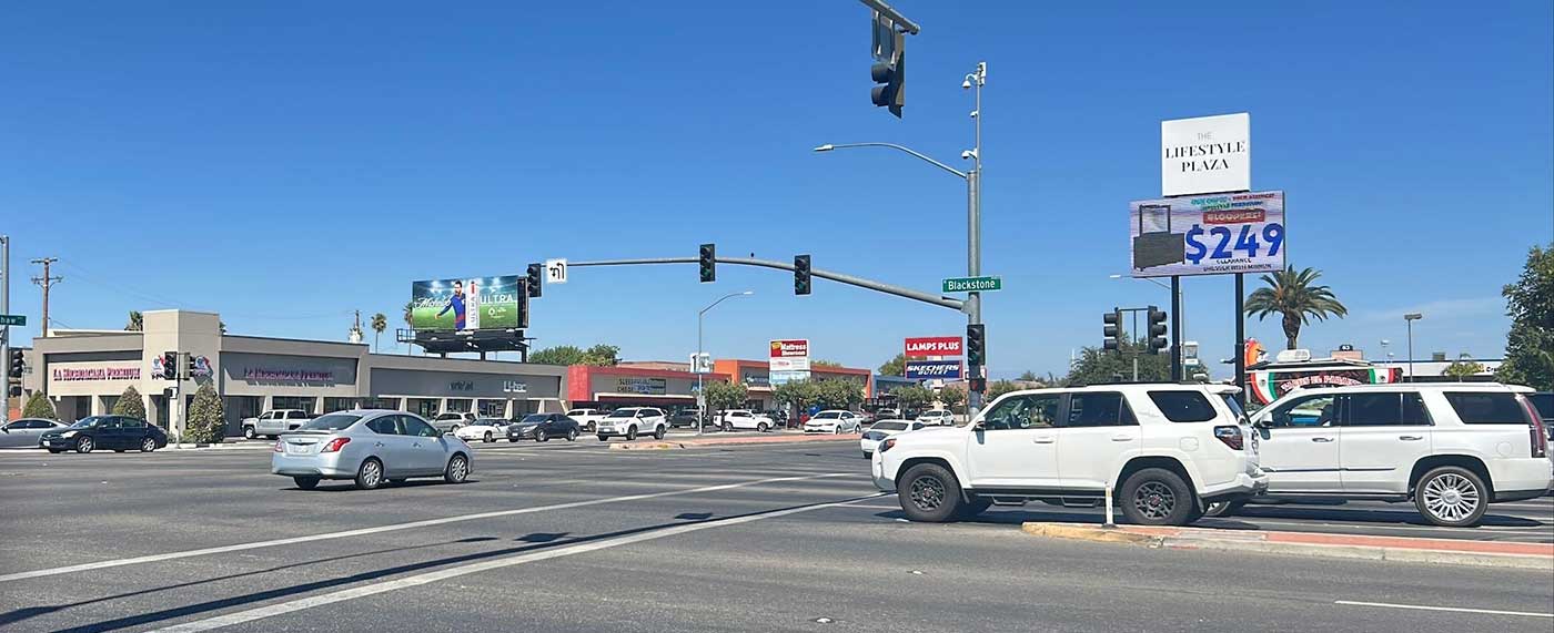 Cars passing through the intersection of Blackstone Avenue and Shaw Avenue in Fresno
