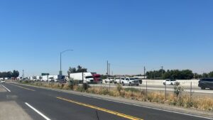 Semi-trucks lined up along Hwy 99 through Madera.