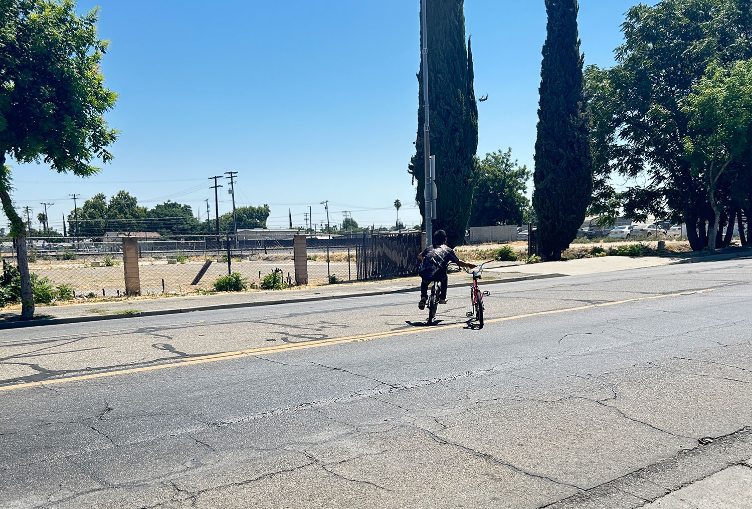 A young bicycle rider near downtown Madera.