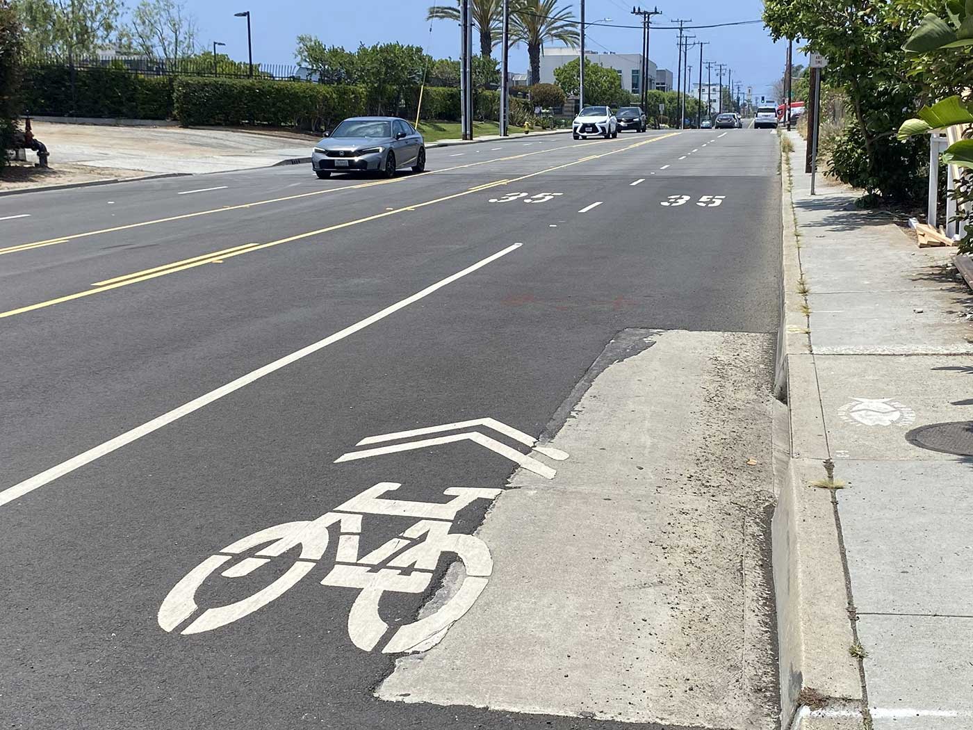 A “sharrow” bicycle lane marking on Grand Avenue with a 35 mph speed limit in El Segundo.
